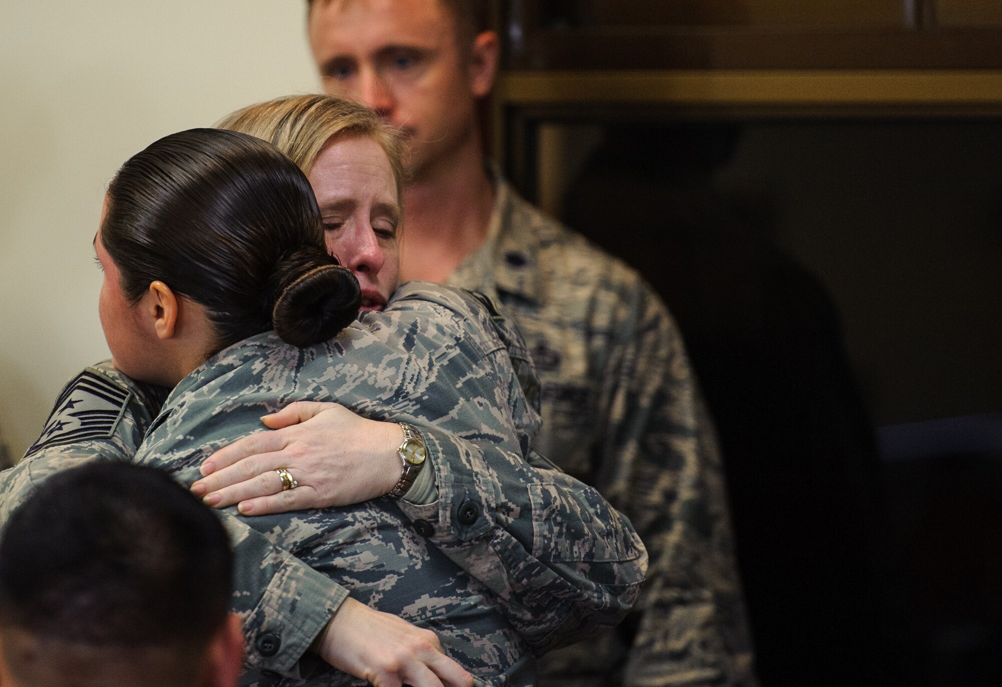 Chief Master Sgt. Rhonda Miller, 8th Fighter Wing command chief, comforts Staff Sgt. Tatiana Carbocci, 8th Security Forces Squadron military working dog handler, after the passing of her military working dog Rico at Kunsan Air Base, Republic of Korea, Feb. 28, 2014. For more than nine years, Rico served the Wolf Pack as an explosive detection dog, ensuring the security of Kunsan. (U.S. Air Force photo by Senior Airman Armando A. Schwier-Morales/Released)