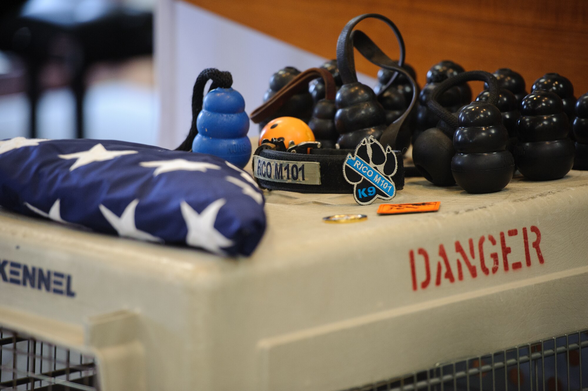 Tributes from Airmen lay atop of military working dog Rico’s kennel during a memorial ceremony after Rico passed away at Kunsan Air Base, Republic of Korea, Feb. 28, 2014. For more than nine years, Rico served the Wolf Pack as an explosive detection dog, ensuring the security of Kunsan. (U.S. Air Force photo by Senior Airman Armando A. Schwier-Morales/Released)