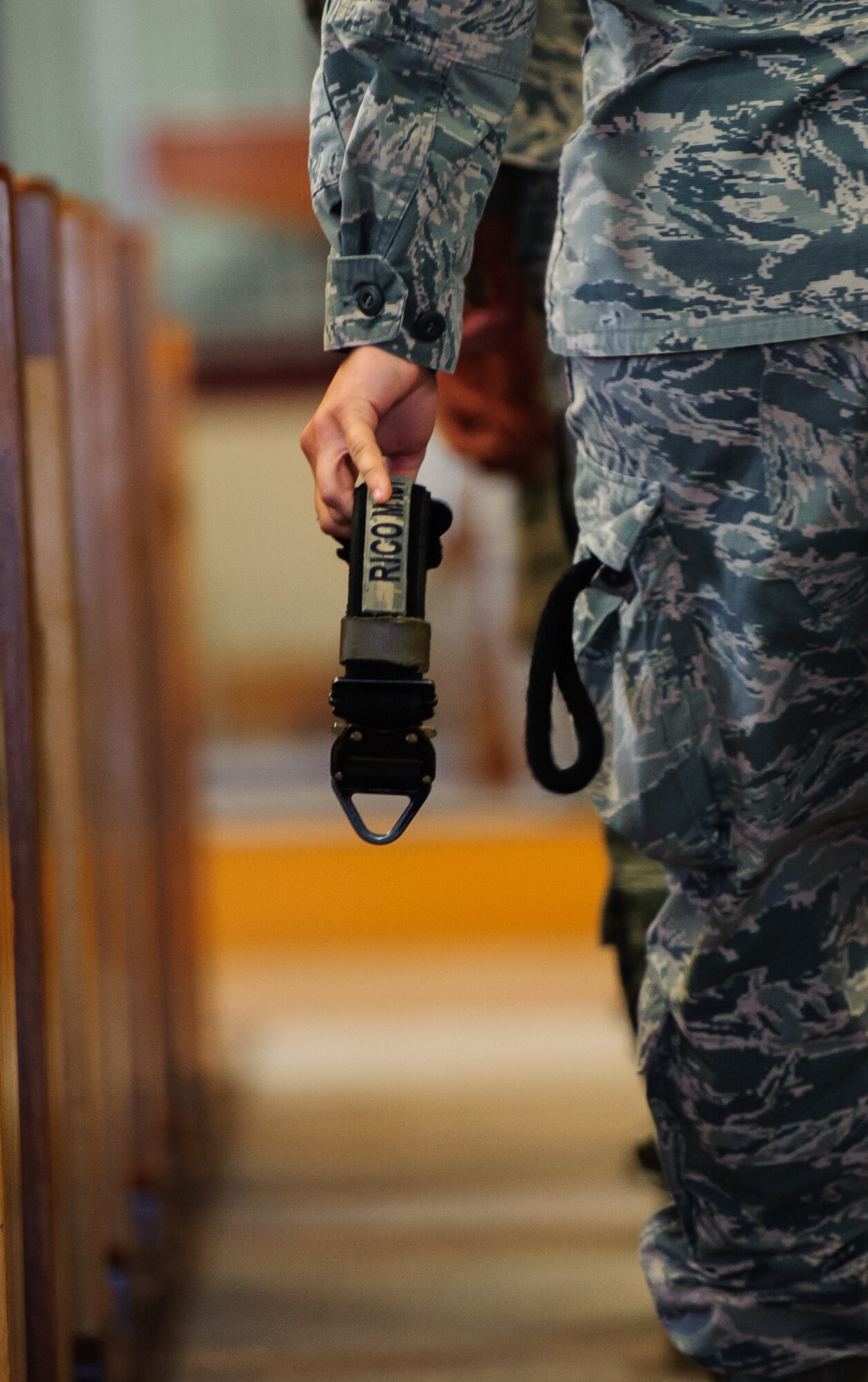 An 8th Security Forces Squadron Airman carries military working dog Rico’s collar during a memorial ceremony at Kunsan Air Base, Republic of Korea, Feb. 28, 2014. For more than nine years, Rico served the Wolf Pack as an explosive detection dog, ensuring the security of Kunsan. (U.S. Air Force photo by Senior Airman Armando A. Schwier-Morales/Released)