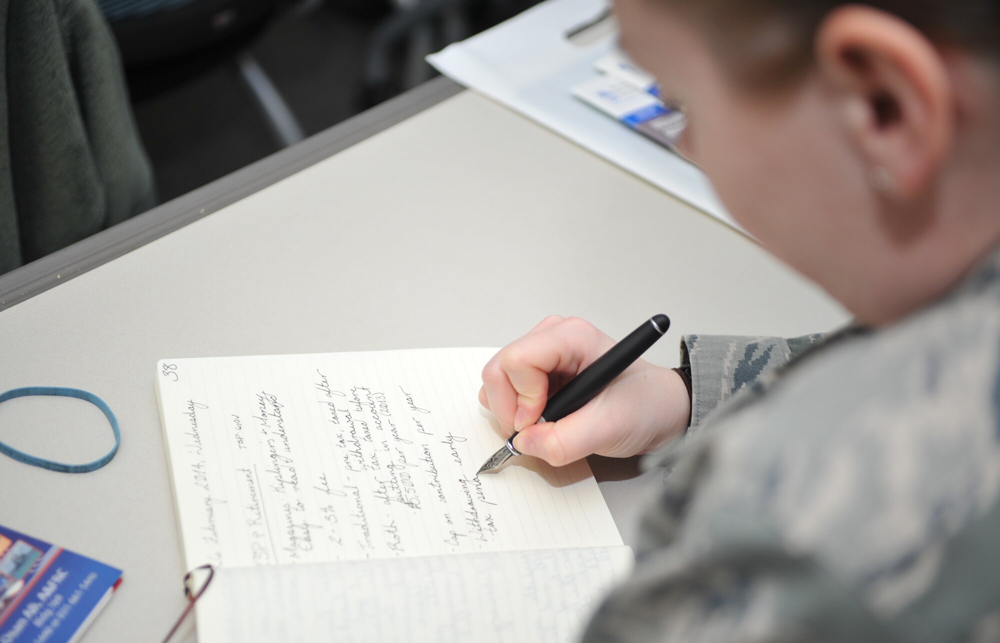 Staff Sgt. Cassandra Lane, 51st Civil Engineer Squadron emergency management journeyman, takes notes during the Military Saves Week thrift savings plan and retirement class in the Airman and Family Readiness Center classroom at Osan Air Base, Republic of Korea, Feb. 26, 2014. Lane attended the class to learn about TSP Roth Individual Retirement Account options that might compliment her current retirement investments. (U.S. Air Force photo/Airman 1st Class Ashley J. Thum)