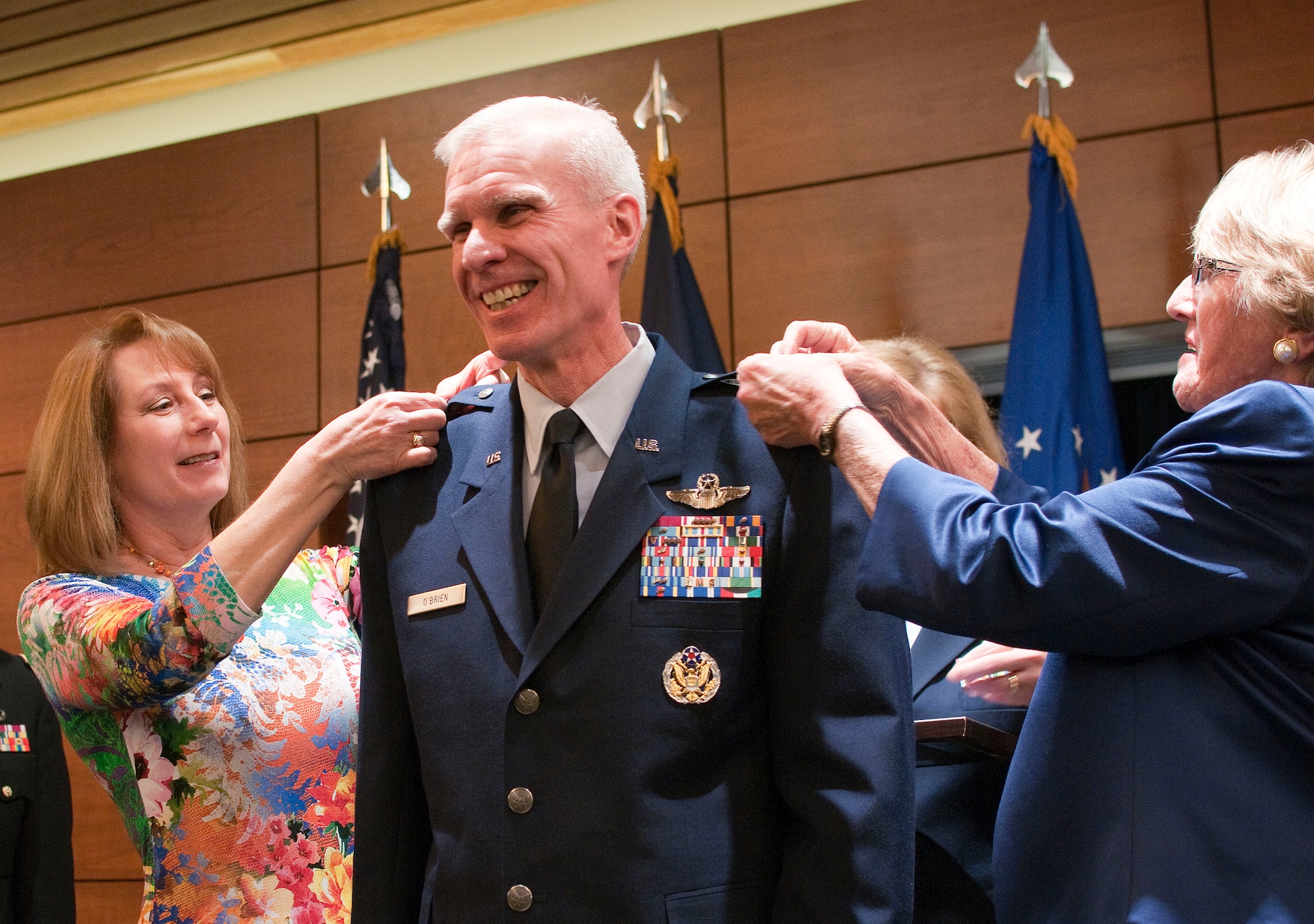 JOINT BASE ELMENDORF RICHARDSON, Alaska -- Timothy P. O'Brien, Alaska's assistant adjutant general for air and commander of the Alaska Air National Guard, receives his general's stars from his wife, Catherine O'Brien, and his mother, Donna O'Brien, at a promotion ceremony here March 2, 2014. O'Brien is responsible for ensuring the training and equipping of the approximately 2,200 men and women of the Alaska Air National Guard. National Guard photo by Tech. Sgt. Jennifer Theulen.