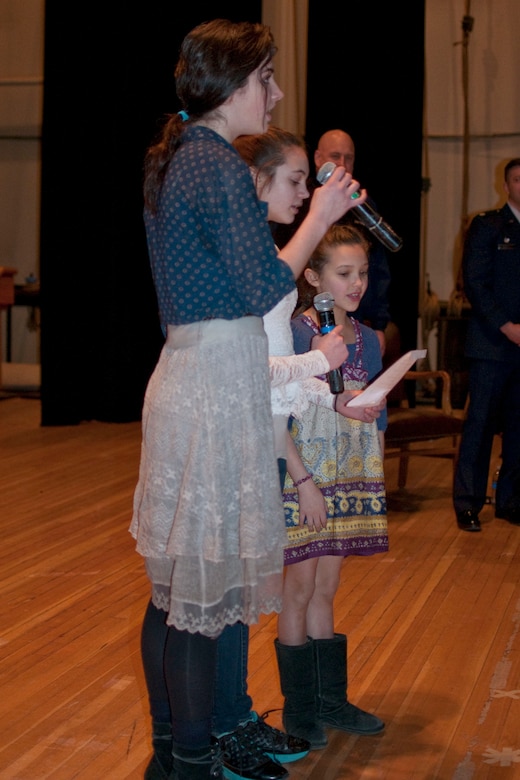 JOINT BASE ELMENDORF-RICHARDSON, Alaska -- Isabella Saxe, age 15, Victoria Saxe, age 12, and Mary Saxe, age 8, practice the Alaska state song before their father's promotion here Feb. 8, 2014. Col. Tory Saxe, commander of the Alaska Air National Guard's 176 Maintenance Group, pinned on the rank of colonel at his ceremony. National Guard photo by Staff Sgt. N. Alicia Halla/Released 