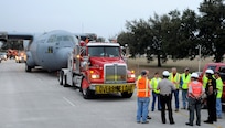 San Antonio Police and local volunteers assist contractor World Wide Aircraft Recovery March 2 with its transport of a retired and partially disassembled Air Force C-130 Hercules cargo aircraft at Joint Base San Antonio-Lackland. The aircraft was relocated to JBSA-Camp Bullis, where it will be used to enhance the training for about 1,300 students attending the 937th Training Group Aeromedical Evacuation and Patient Staging Course, annually. (U.S. Air Force photo by Airman 1st Class Alexandria Slade)