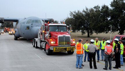San Antonio Police and local volunteers assist contractor World Wide Aircraft Recovery March 2 with its transport of a retired and partially disassembled Air Force C-130 Hercules cargo aircraft at Joint Base San Antonio-Lackland. The aircraft was relocated to JBSA-Camp Bullis, where it will be used to enhance the training for about 1,300 students attending the 937th Training Group Aeromedical Evacuation and Patient Staging Course, annually. (U.S. Air Force photo by Airman 1st Class Alexandria Slade)