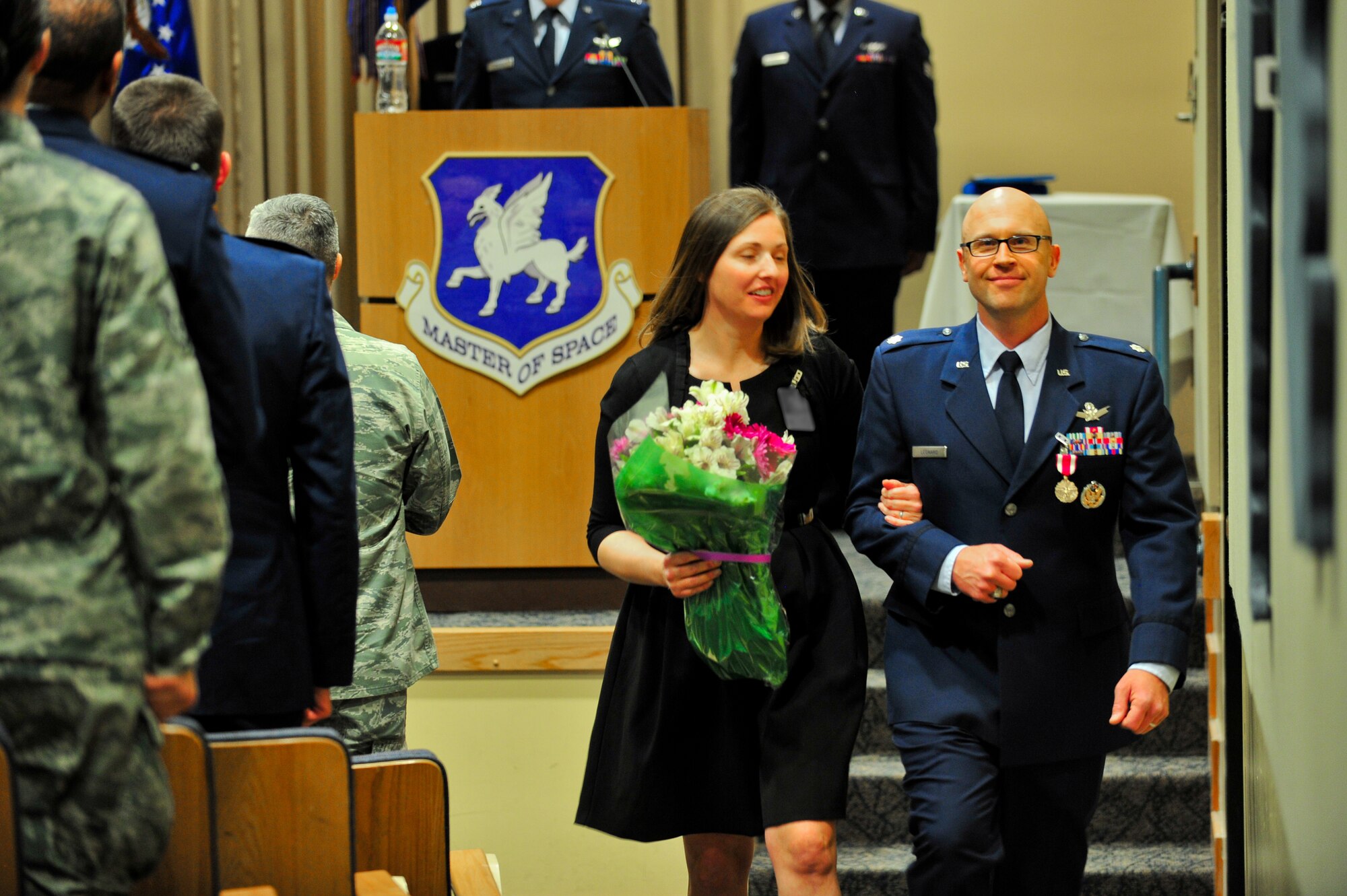 Air Force Reserve Lt. Col. Leland K. Leonard departs his assumption of command ceremony with his wife March 1, 2014 on Schriever Air Force Base, Colo. Leonard assumed command of the squadron during the ceremony. (U.S. Air Force photo/Tech. Sgt. Nicholas B. Ontiveros)