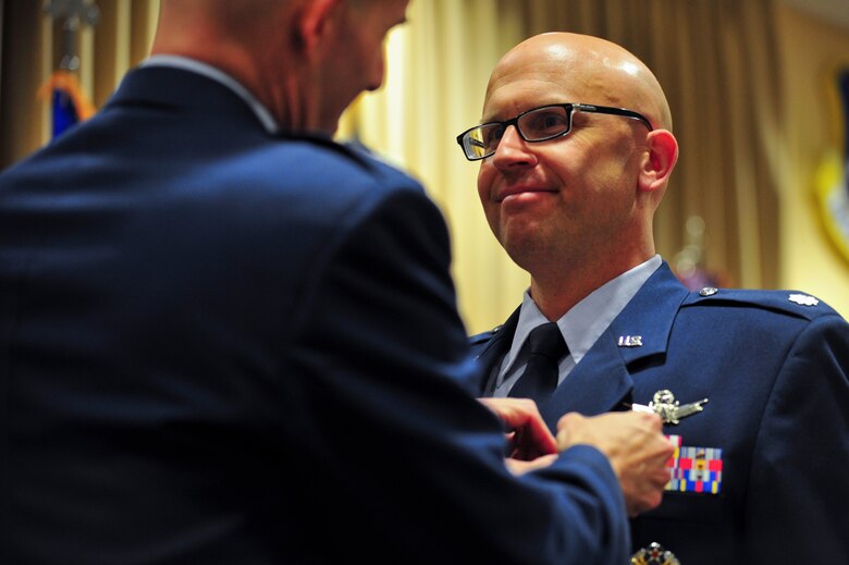 Air Force Reserve Lt. Col. Michael A. Assid, acting 310th Operations Group commander, awards the Air Force Meritorious Service Medal to AF Reserve Lt. Col. Leland K. Leonard prior to his assumption of command ceremony March 1, 2014 on Schriever Air Force Base, Colo. The MSM is a military decoration presented to members of the United States Armed Forces who distinguishes  themselves through outstanding meritorious achievement or service to the United States. Leonard assumed command of the 7th Space Operations Squadron during the ceremony. (U.S. Air Force photo/Tech. Sgt. Nicholas B. Ontiveros)