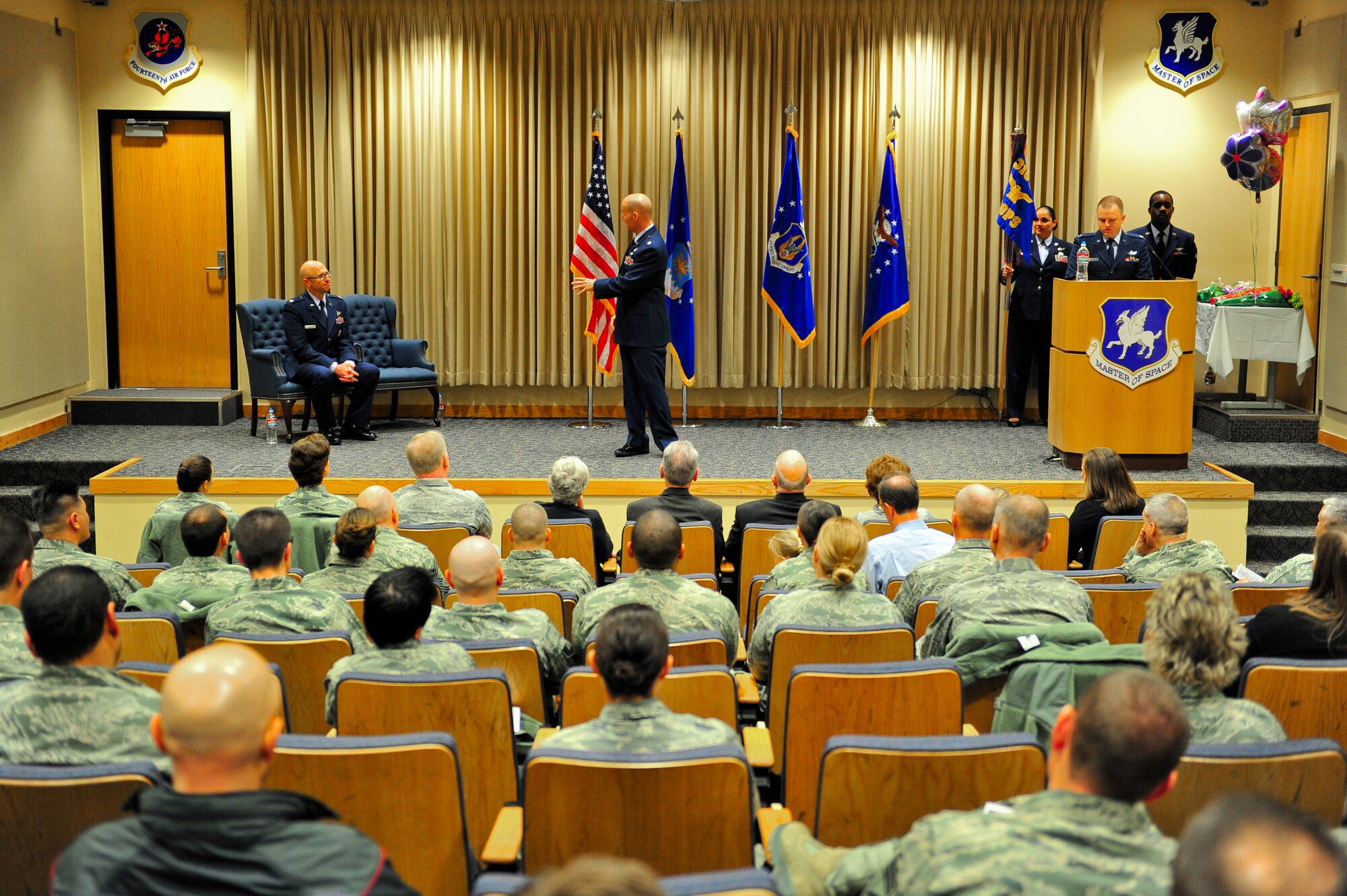 Air Force Reserve Lt. Col. Michael A. Assid, acting 310th Operations Group commander, highlights the qualifications and accomplishments of AF Reserve Lt. Col. Leland K. Leonard to an audience of Airmen and Leonard's family March 1, 2014 on Schriever Air Force Base, Colo. Leonard assumed command of the 7th Space Operations Squadron during the ceremony. (U.S. Air Force photo/Tech. Sgt. Nicholas B. Ontiveros)