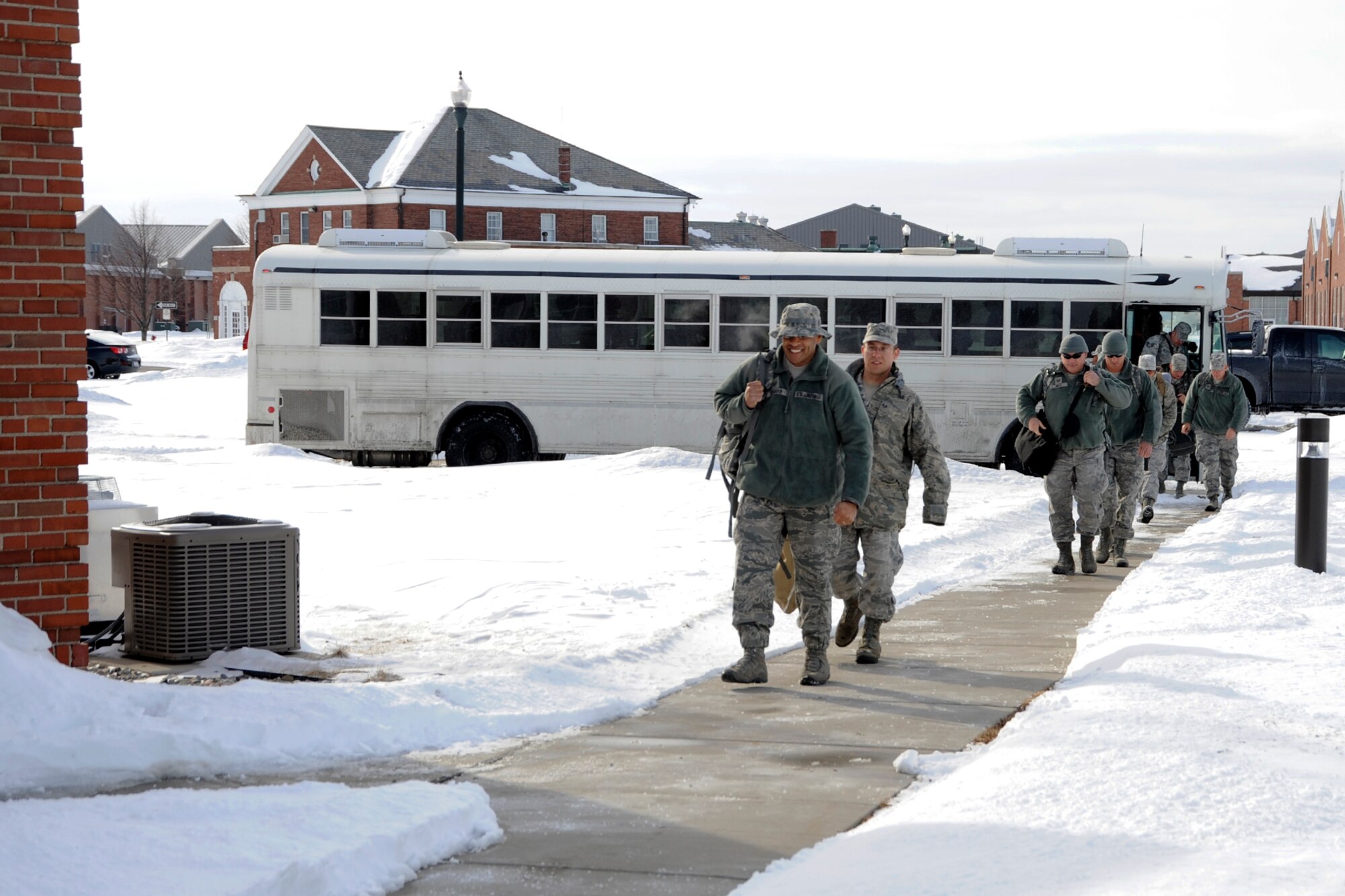 Security Forces Squadron Airmen from the 127th Wing step off the final bus before greeting their friends and families on March 2, 2014, at Selfridge Air National Guard Base, Mich., after a six month deployment. (U.S. Air National Guard photo by John S. Swanson / Released)