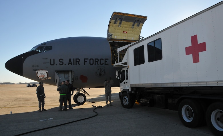 A medical transport vehicle from the 79th Medical Wing, Joint Base Andrews, Md., loaded with patients ready for aeromedical transport raises up to the open cargo hatch of a KC-135 Stratotanker assigned to the 128th Air Refueling Wing, Milwaukee, on the ramp at JBA. Jan 13, 2014. The patients were transported to other military medical treatment facilities around the country by an aeromedical evacuation team demonstrating total force integration on an aeromedical evacuation mission. (U.S. Air National Guard photo by Staff Sgt. Jeremy Wilson/Released)