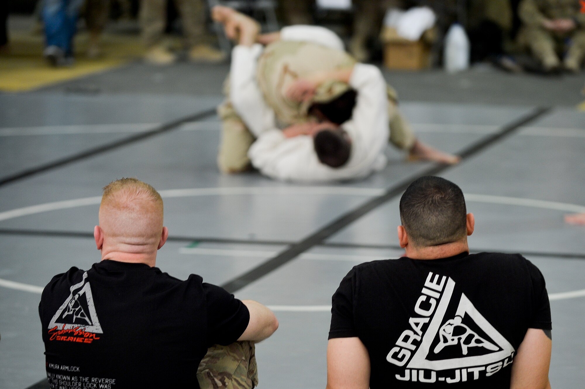 The Jiu-Jitsu club hosted the 2nd annual tournament at Bagram Airfield, Afghanistan, March 1, 2014. Jiu-Jitsu is a martial art with a foundation of self-defense and the tournament had approximately 85 participants. (U.S. Air Force photo by Senior Airman Kayla Newman/Released) (Image was lightened and cropped to emphasize subjects.)
