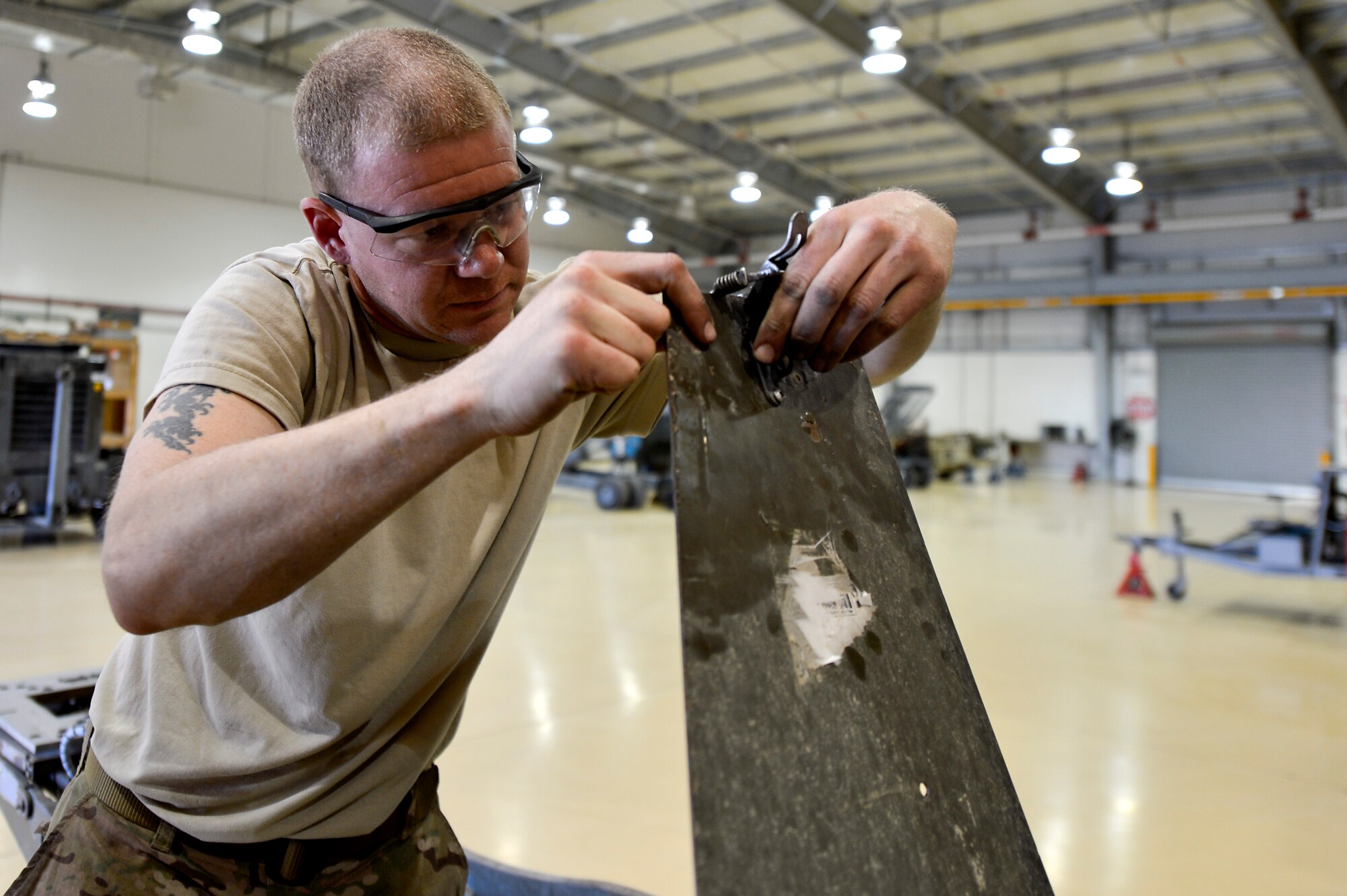 U.S. Air Force Senior Airman John Little, 455th Expeditionary Maintenance Squadron AGE technician, conducts an inspection on a bomb lift at Bagram Airfield, Afghanistan, Feb. 28, 2014. AGE is responsible for maintenance on approximately 450 pieces of equipment used to maintain the aircraft at Bagram. (U.S. Air Force photo by Senior Airman Kayla Newman/Released)