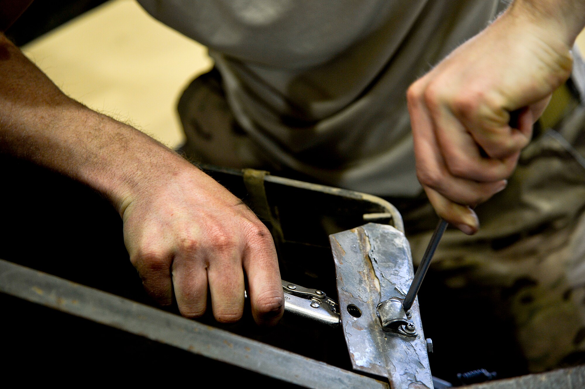 U.S. Air Force Senior Airman John Little, 455th Expeditionary Maintenance Squadron AGE technician, works on a bomb lift at Bagram Airfield, Afghanistan, Feb. 28, 2014. AGE is responsible for maintenance on equipment used to maintain the aircraft at Bagram. (U.S. Air Force photo by Senior Airman Kayla Newman/Released)