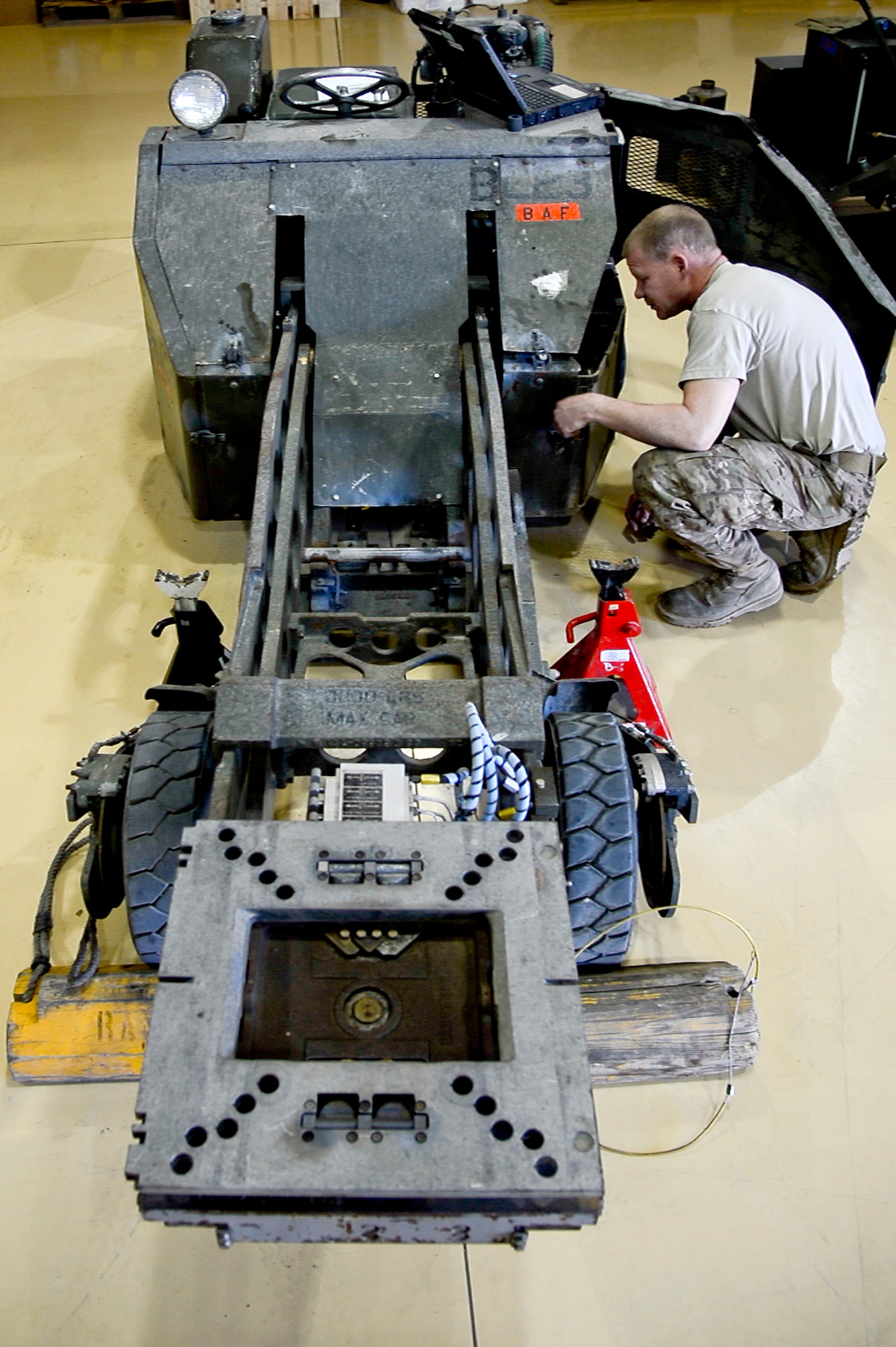 U.S. Air Force Senior Airman John Little, 455th Expeditionary Maintenance Squadron AGE technician, conducts an inspection on a bomb lift at Bagram Airfield, Afghanistan, Feb. 28, 2014. AGE maintains, services and performs operation checks on the ground equipment used on the aircraft at Bagram.  (U.S. Air Force photo by Senior Airman Kayla Newman/Released)