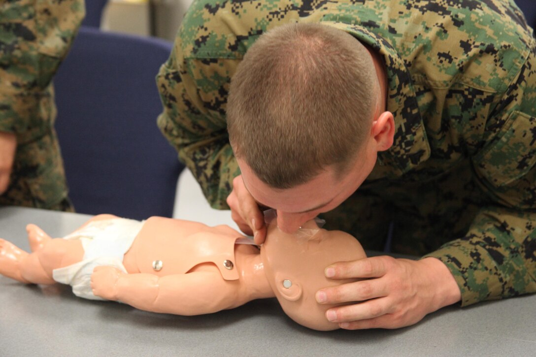 Cpl. Brett R. Jacoby performs CPR on an infant mannequin during a CPR and Automated External Defibrillator class at the Jerry Marvel Training and Education Building at Marine Corps Air Station Cherry Point, Feb. 19, 2014. Jacoby is a refrigeration and air conditioning mechanic with Marine Tactical Air Command Squadron 28.