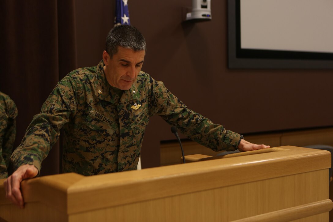 Navy Lt. Cmdr. John Van Dyke, the chaplain for Headquarters Battalion, 2nd Marine Division, leads prayer for Marines, sailors, families and friends in attendance for the Morning Awards Ceremony aboard Marine Corps Base Camp Lejeune Feb. 27, 2014. Two Marines and three sailors were recognized for outstanding performance.