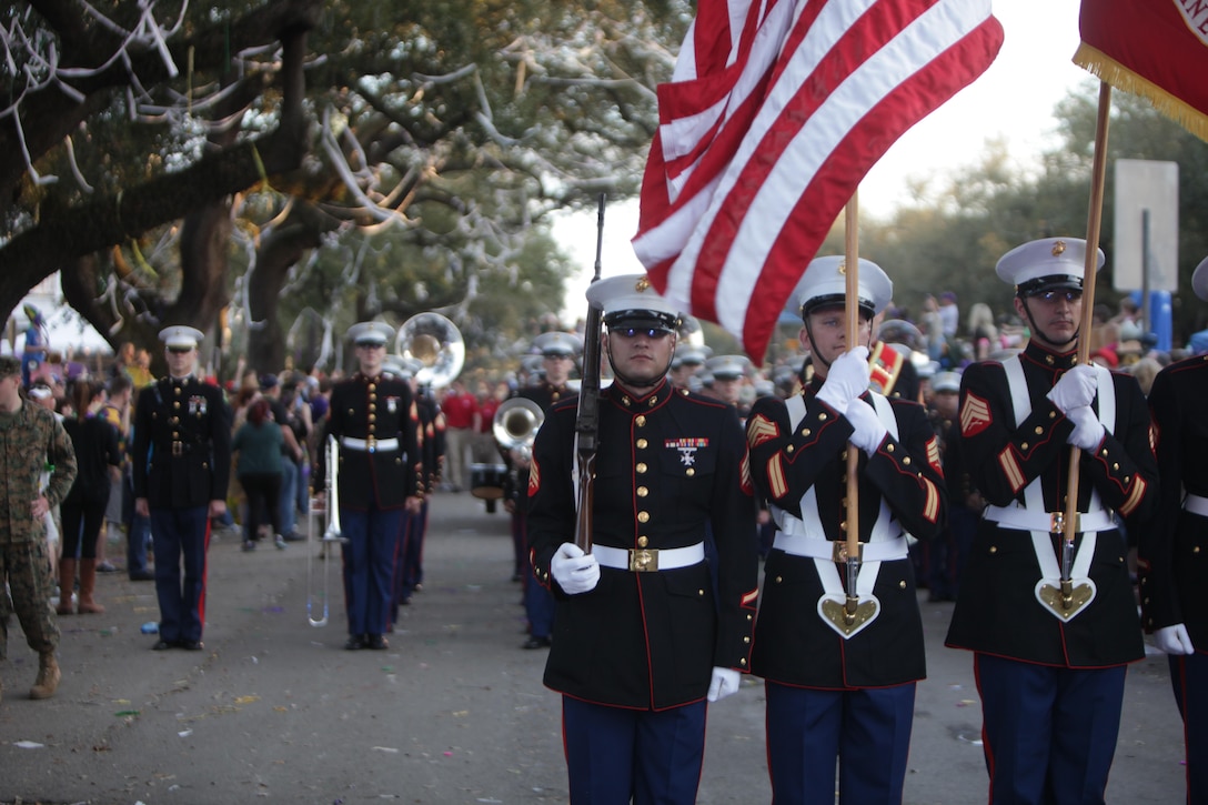 The Marine Forces Reserve Color Guard and Marine Corps Band New Orleans stop during a pause in the Krewe of Bacchus parade here, March 2, 2014. The Marines led the parade Sunday evening bringing many cheers and “Ooh-Rah’s” from the crowd. (Marine Corps photo by Lance Cpl. Brytani Musick)
