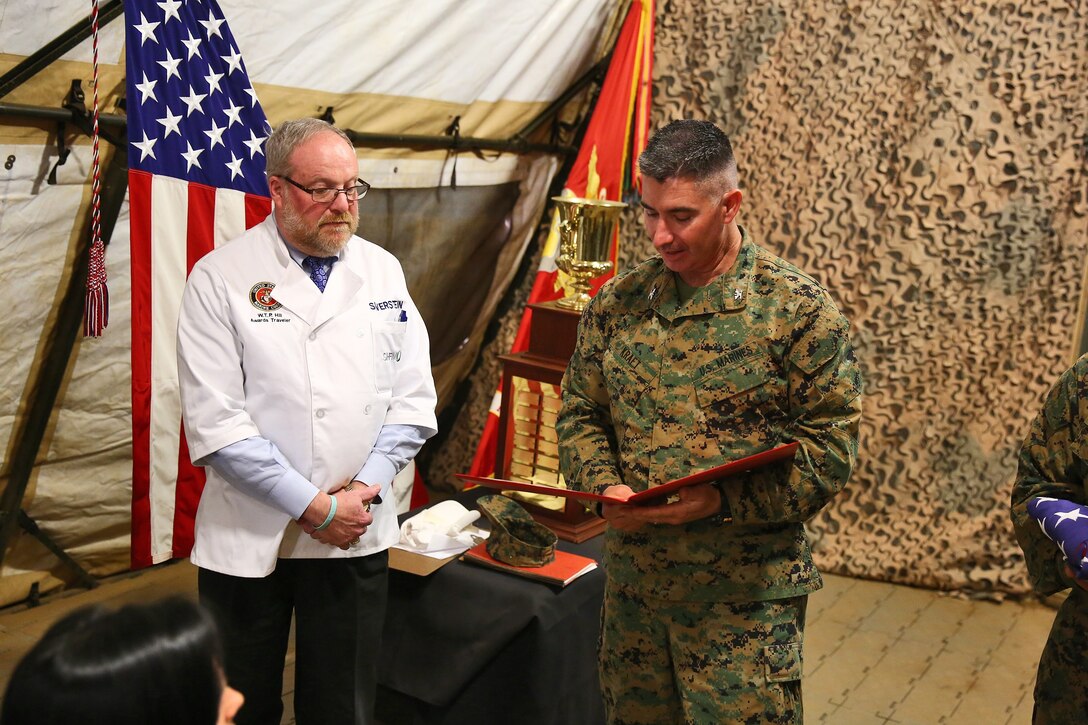 Colonel Erik B. Kraft (right), commanding officer, Combat Logistics Regiment 17, 1st Marine Logistics Group, presents a letter of appreciation and American Flag to Jay Silverstein, vice president of Hospitality Services, Credit Suisse, during a Major General W.P.T. Hill Memorial Award competition aboard Camp Pendleton, Calif., Feb. 26, 2014. Silverstein was selected to be a W.P.T. awards traveler and judge of the competition. The Marines defended their title as the best field mess in the Marine Corps, which they earned during last year’s awards, competing against the best selected food service units the Marine Corps has to offer.