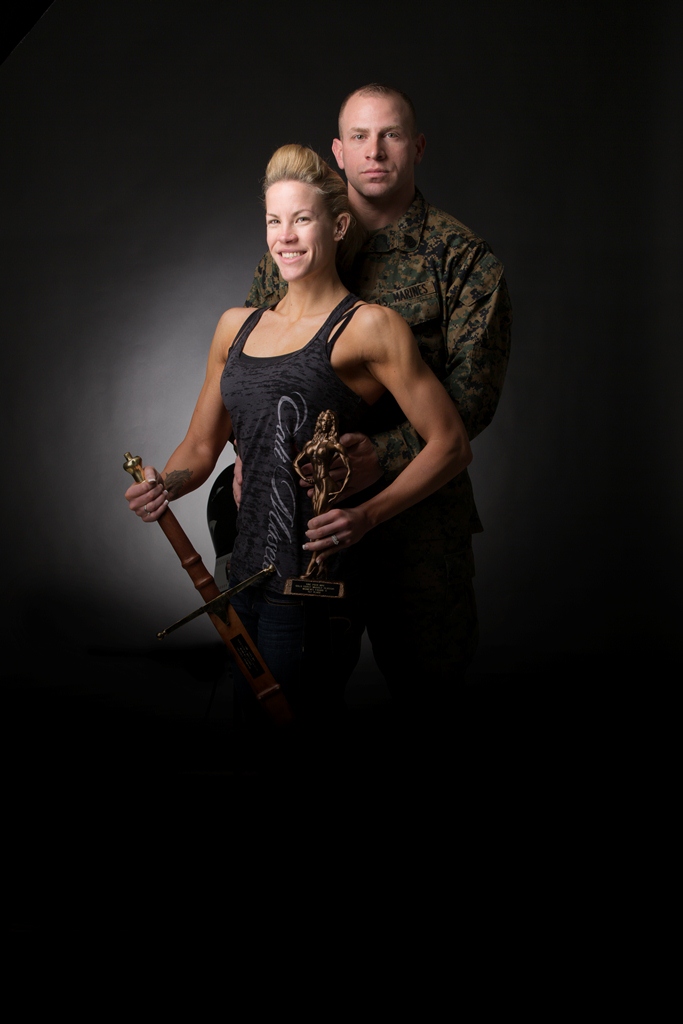 Katherine Garcia, figure competitor and spouse of Russell Garcia, communications chief on Marine Corps Logistics Base Barstow, Calif., (right) pose after Katherine won the National Physique Competition, Gold Coast Classic, in Culver City, Calif., Feb. 8. Katherine won the trophy for winning her height category and the sword for winning the overall physique competition.


