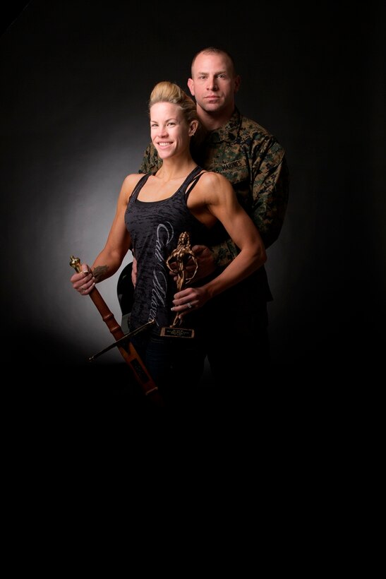 Katherine Garcia, figure competitor and spouse of Russell Garcia, communications chief on Marine Corps Logistics Base Barstow, Calif., (right) pose after Katherine won the National Physique Competition, Gold Coast Classic, in Culver City, Calif., Feb. 8. Katherine won the trophy for winning her height category and the sword for winning the overall physique competition.


