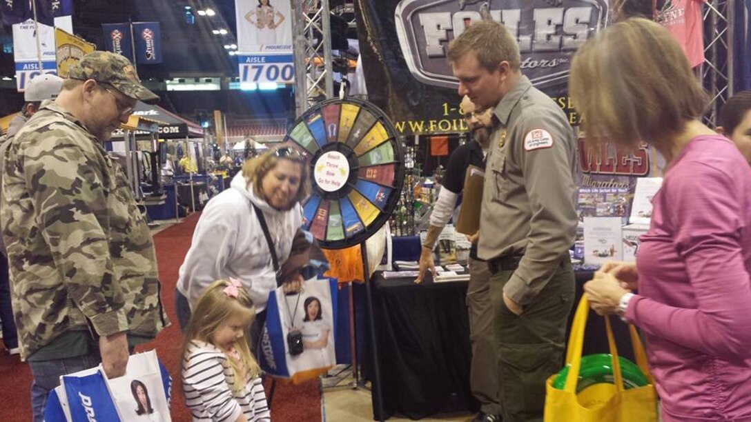 St. Louis District Corps of Engineers ranger talks with a young girl and her family about water safety at the St. Louis Boat & Sports Show March 1, 2014 at the America's Center in St. Louis, Mo.