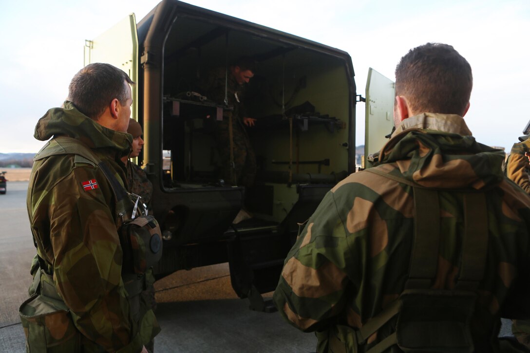 Petty Officer 2nd Class Adam J. Voegtle (center), a Belleville, Ill., native and hospital corpsman with 2nd Supply Battalion, Combat Logistics Regiment 25, 2nd Marine Logistics Group, teaches medical officers with Evacuation Company Task Unit, Host Nation Support Battalion about U.S. military ambulances at Vaernes Garrison, Norway, Feb. 27, 2014. U.S. Navy corpsmen and Norwegian army medical officers shared knowledge of each county’s equipment in preparation for joint medical care during Cold Response 2014.