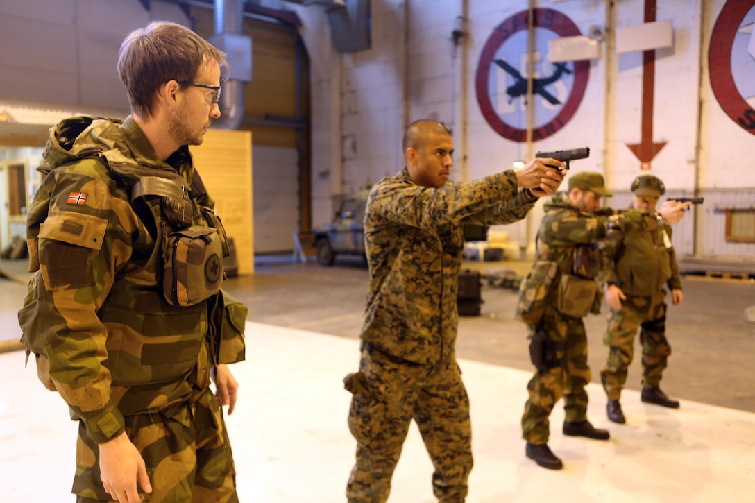 Capt. Thomas T. Moe, an Oslo, Norway, native and doctor with, Host Nation Support Battalion practice sighting in with Glock P-80s in an indoor firing range at Vaernes Garrison, Norway, Feb. 27, 2014. U.S. Navy corpsmen and Norwegian army medical officers trained together to gain a greater appreciation for each nation’s medical techniques and to increase interoperability between the countries.