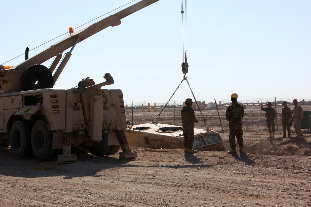 Afghan soldiers with the 3rd Mobile Strike Force communicate during vehicle recovery training with Mine-Resistant Ambush-Protected vehicles with simulated battle damage aboard Camp Leatherneck, Helmand province, Afghanistan, Feb. 23, 2014. Marines with MSF Security Force Assistance Advisor Team have been working with the 3rd MSF since August, teaching the soldiers basic vehicle maintenance and proper vehicle recovery in order to sustain continuous combat operations.