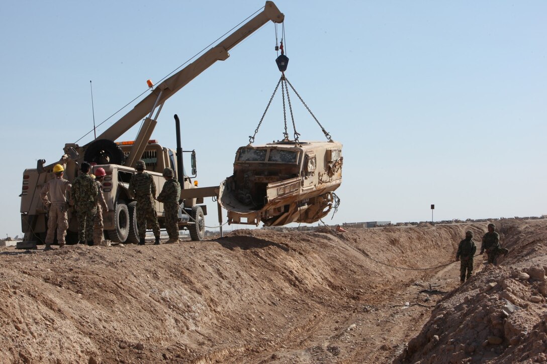 Afghan soldiers with the 3rd Mobile Strike Force successfully lift a Mine-Resistant Ambush-Protected vehicle with simulated battle damage out of a ditch during vehicle recovery training aboard Camp Leatherneck, Helmand province, Afghanistan, Feb. 23, 2014. Marines with MSF Security Force Assistance Advisor Team have been working with the 3rd MSF since August, teaching the soldiers basic vehicle maintenance and proper vehicle recovery in order to sustain continuous combat operations.