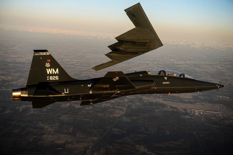 A T-38 Talon flies in formation with the B-2 Spirit of South Carolina during a training mission Feb. 20, 2014, over Whiteman Air Force Base, Mo. The B-2 Spirit is a multirole bomber capable of delivering both conventional and nuclear munitions. (U.S. Air Force photo/Staff Sgt. Jonathan Snyder) 