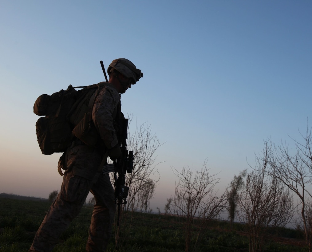 An infantry Marine with 3rd Platoon, Charlie Company, 1st Battalion, 9th Marine Regiment, walks across a field during a security patrol in Helmand province, Afghanistan, Feb. 20, 2014. Security patrols take place daily to ensure a continuous military presence in the area surrounding Patrol Base Boldak. (U.S. Marine Corps photo by Cpl. Cody Haas/ Released)
