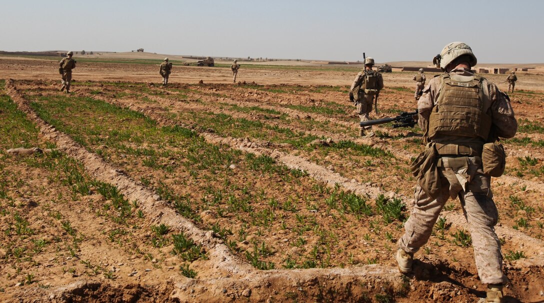A team of infantry Marines with 3rd Platoon, Charlie Company, 1st Battalion, 9th Marine Regiment, patrols across a field during a security patrol in Helmand province, Afghanistan, Feb. 21, 2014. Security patrols take place daily to ensure a continuous military presence in the area surrounding Patrol Base Boldak. (U.S. Marine Corps photo by Cpl. Cody Haas/ Released)