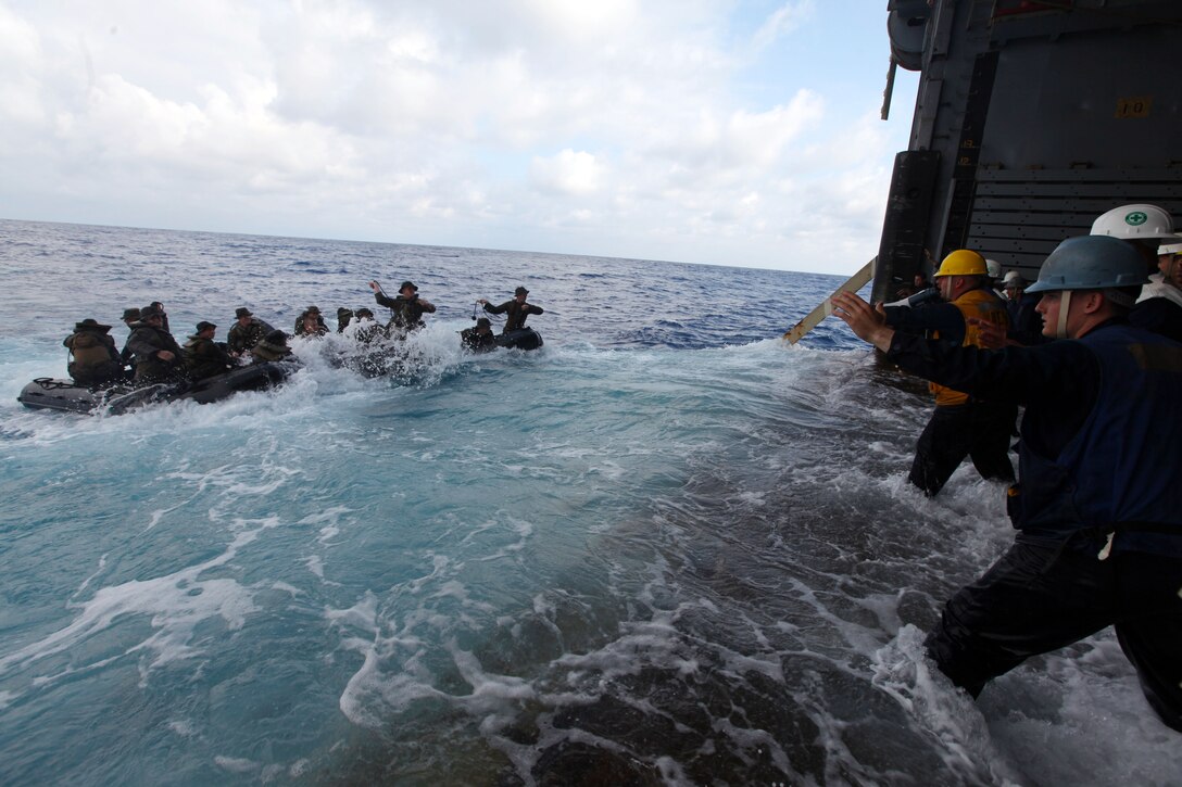 USS DENVER, At Sea – Marines of Company F., Battalion Landing Team 2nd Battalion, 5th Marines, 31st Marine Expeditionary Unit, toss heaving lines to crew members while practicing launch and recovery operations in Combat Rubber Raiding Craft here, March 1. The 31st MEU recently embarked on three ships of Amphibious Squadron 11 to begin their regularly scheduled Spring Patrol. The USS Denver is currently transporting Company F, as well as small detachments of Weapons Company, the Command Element, Combat Logistics Battalion 31, and Marine Medium Tiltrotor Squadron 265 (Reinforced). The 31st MEU is the Marine Corps’ force in readiness for the Asia-Pacific region and the only continuously forward-deployed MEU. (Marine Corps photo by Sgt. Paul Robbins Jr.)