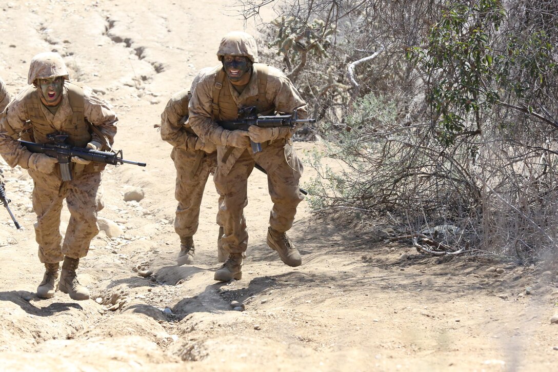 Pfc. Lucas M. Polk (center), Platoon 1035, Company B, 1st Recruit Training Battalion, climbs a hill during the Basilone’s Challenge event during the Crucible at Edson Range aboard Marine Corps Base Camp Pendleton, Feb. 19. Polk is a third generation Marine that has graduated recruit training from Marine Corps Recruit Depot San Diego.