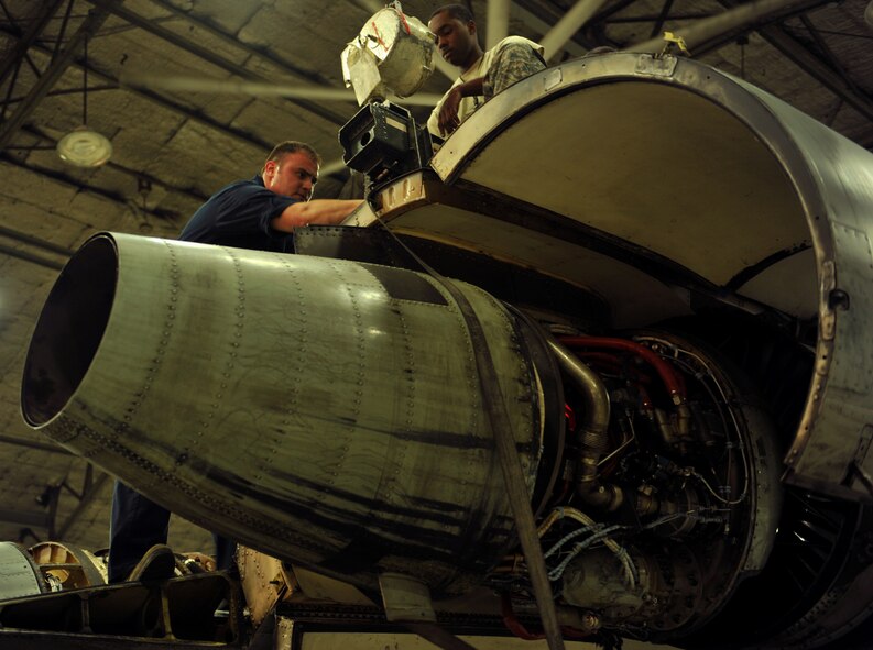 Tech. Sgt. John Perez, 51st Maintenance Squadron propulsion section lead technician, guides an A-10 Thunderbolt II engine into place at Osan Air Base, Republic of Korea, Feb. 28, 2014. Aerospace propulsion specialists from the 51st MXS ensure A-10 engines are in first-rate operational condition. (U.S. Air Force photo/Senior Airman Siuta B. Ika)