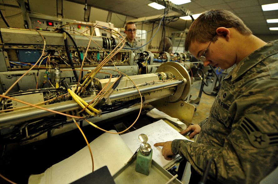 Senior Airman Jonathon Buck, 51st Maintenance Squadron electronic warfare technician, reads through a technical order on an AN/ALQ-184 electronic countermeasure pod at Osan Air Base, Republic of Korea, Feb. 28, 2014. This ECM pod protects aircraft against radio frequency threats by selectively directing high-power jamming against multiple emitters. (U.S. Air Force photo/Senior Airman Siuta B. Ika)