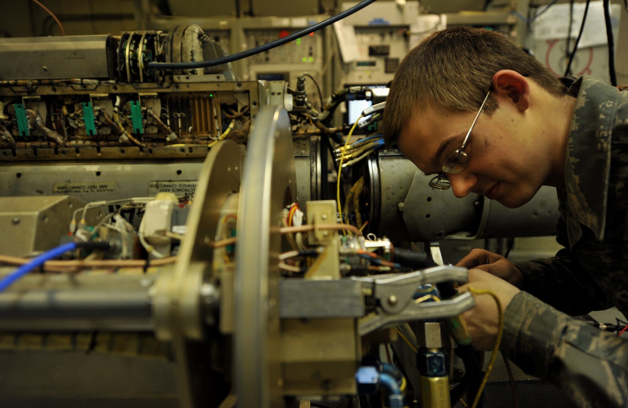 Senior Airman Jonathon Buck, 51st Maintenance Squadron electronic warfare technician, checks the functionality of a component on an AN/ALQ-184 electronic countermeasure pod at Osan Air Base, Republic of Korea, Feb. 28, 2014. This ECM pod protects aircraft against radio frequency threats by selectively directing high-power jamming against multiple emitters. (U.S. Air Force photo/Senior Airman Siuta B. Ika)