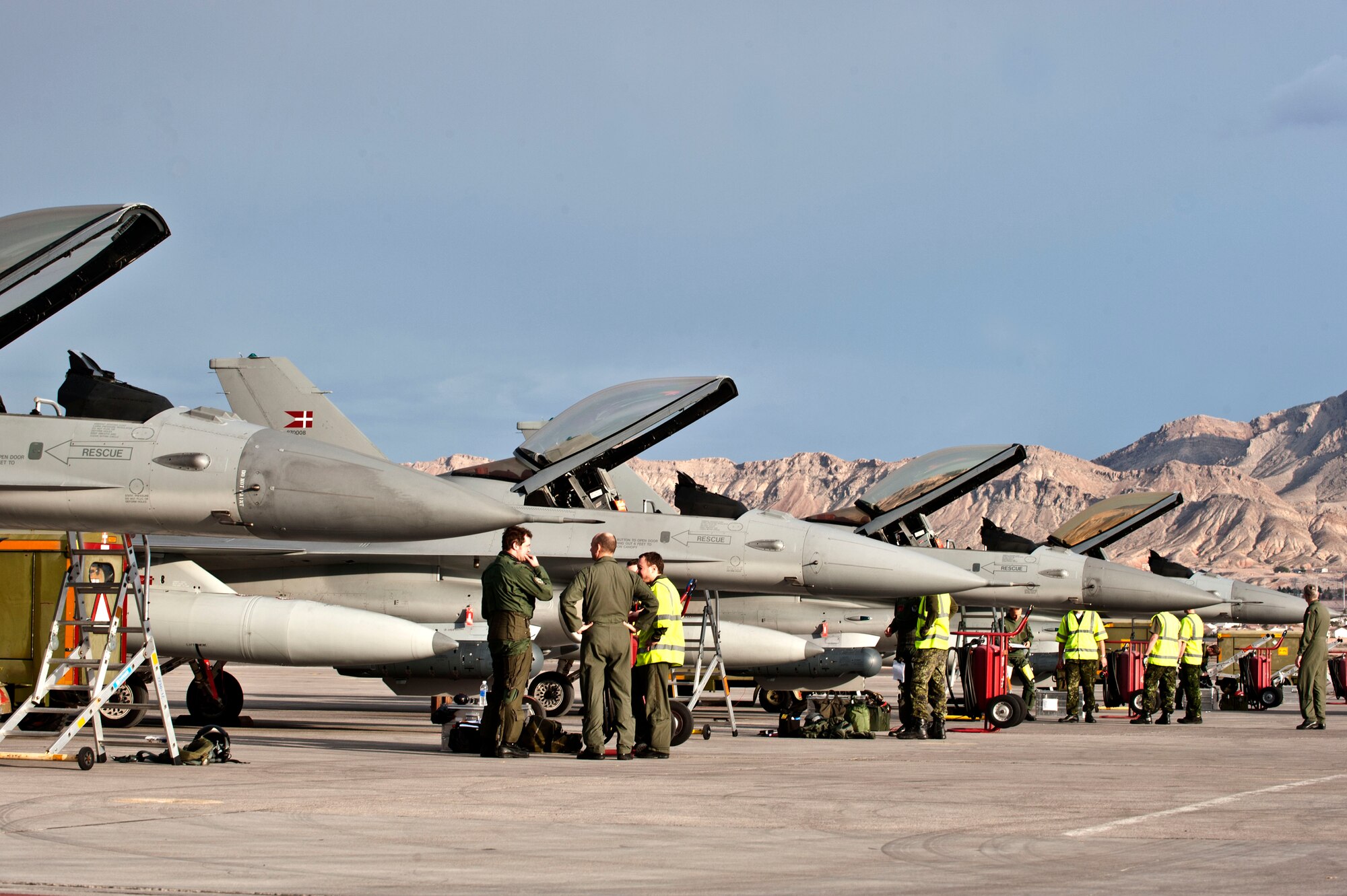 Royal Danish Air Force F-16 Fighting Falcons assigned to the 730th and 727th Fighter Squadrons, Skyrdstrup Air Base, Denmark, park on the Nellis Air Force Base, Nev. flightline in preparation for Red Flag 14-2, Feb. 26, 2014.  During Red Flag, the U.S. Air Force plays host to multiple simulated air wars by providing realistic training possible for joint U.S. and coalition pilots. (U.S. Air Force photo by Senior Airman Matthew Lancaster)