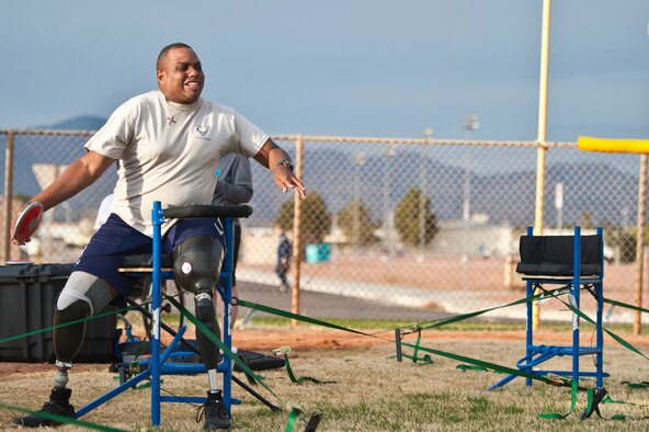 Vincent Pacely, an Air Force Wounded Warrior Adaptive Sports Camp participant, prepares to throw a discus during adaptive sports camp, held at the Warrior Fitness Center, Feb. 26, 2014, at Nellis Air Force Base, Nev.  The camp is designed to introduce wounded warriors to sports featured in Paralympic Warrior Games. (U.S. Air Force photo by Senior Airman Christopher Tam)