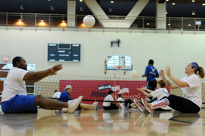 Air Force Wounded Warrior Adaptive Sports Camp participants undergo a basic sit volleyball orientation clinic in the Warrior Fitness Center Feb. 25, 2014, at Nellis Air Force Base, Nev. The camp was held from Feb. 25 to 27 and consisted of multiple sports. (U.S. Air Force photo by Airman 1st Class Timothy Young)