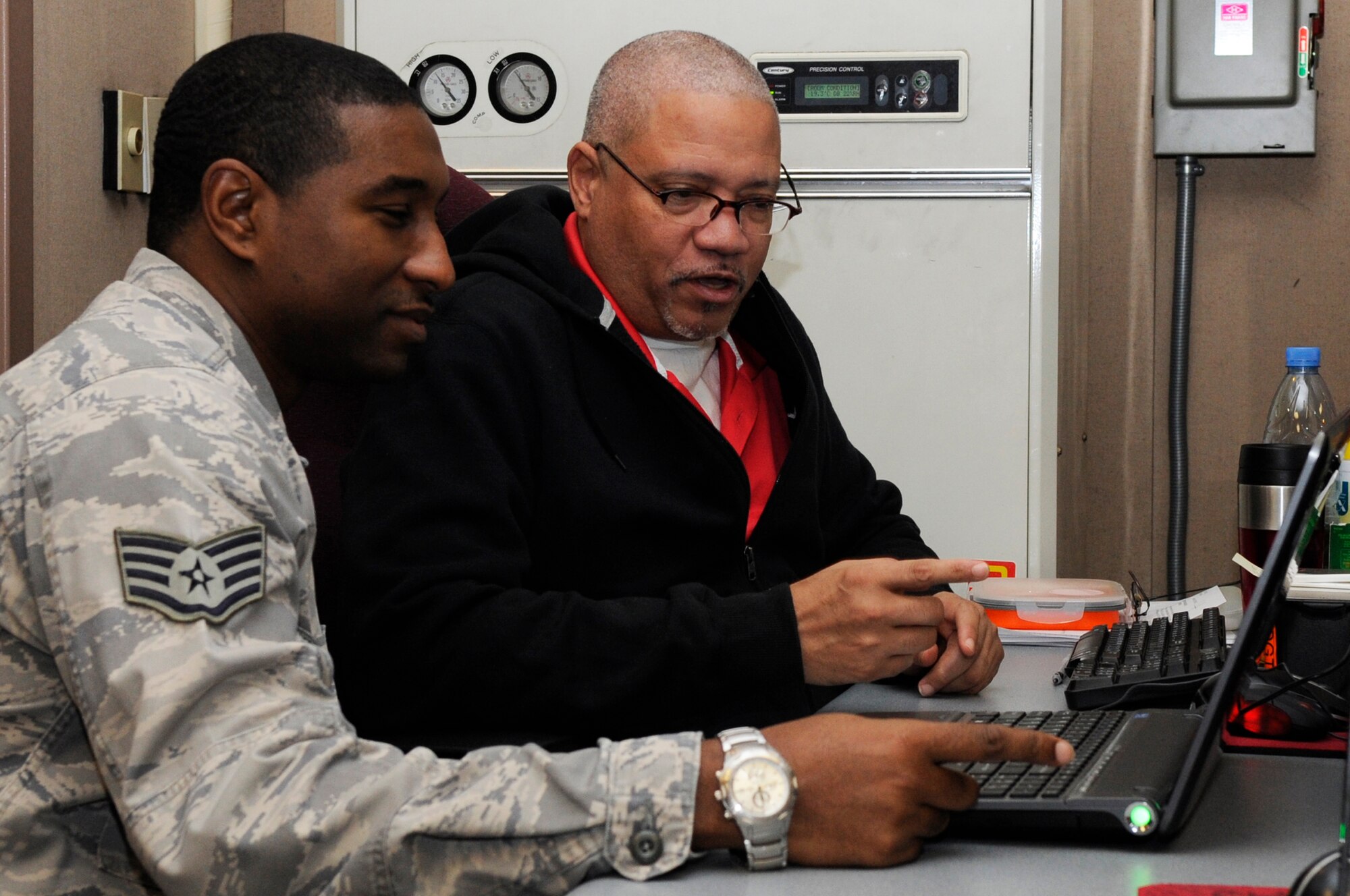 Staff Sgt. Mikkel McKoy and George Harris, 7th Air Force, log simulation model controllers, create graphically represented, synthetic environments for training and mission planning during Exercise Key Resolve 2014 at Osan Air Base Republic of Korea, Feb. 28, 2014. The KASC uses modeling and simulation technology to create graphically represented, synthetic environments for training and mission planning that challenge decision makers while testing strategy, plans and doctrine. (U.S. Air Force photo/ Senior Airman Marcus Morris)