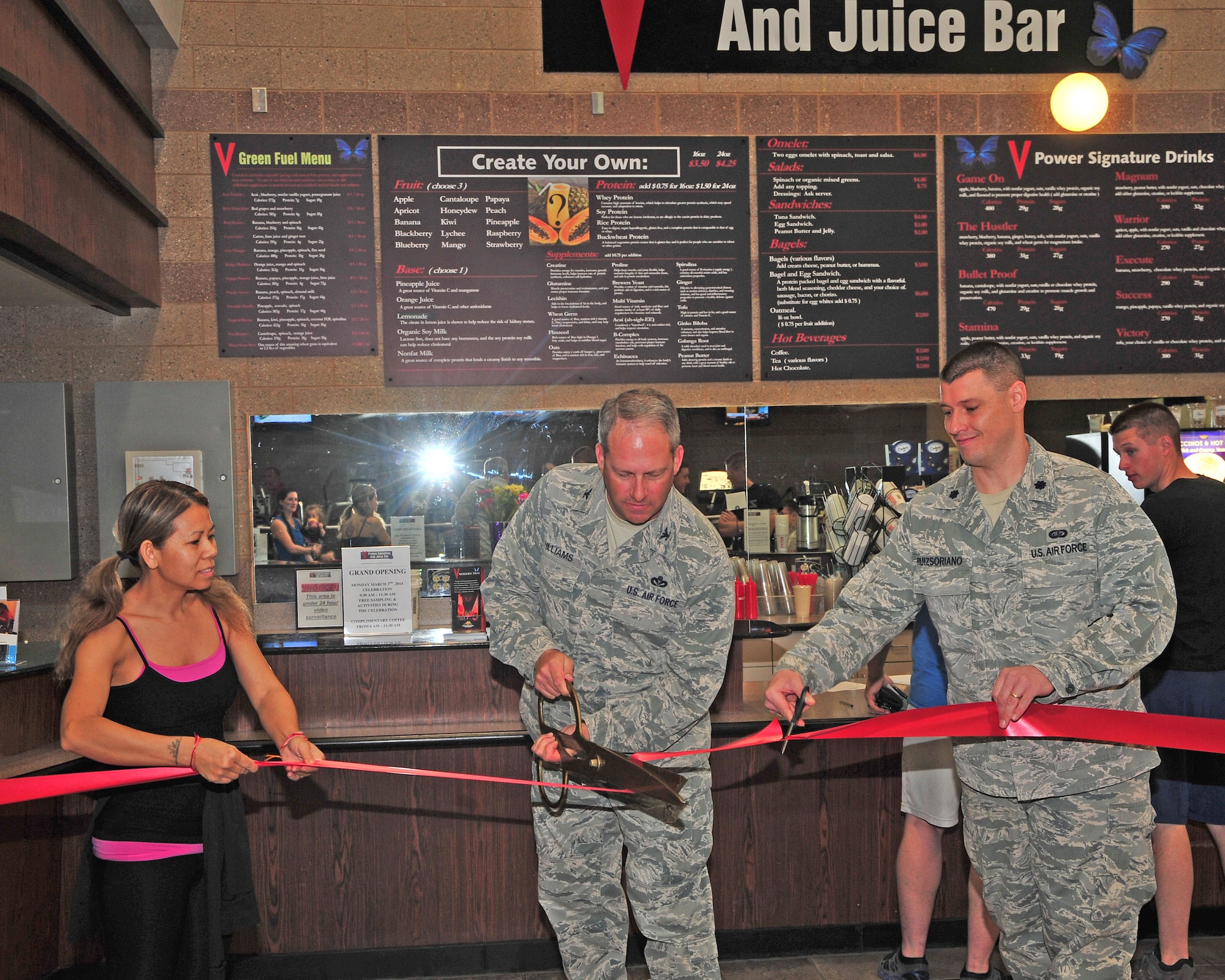 U.S. Air Force Col. Greg Williams, 355th Mission Support Group commander, cuts the ribbon to signify the official opening of the juice bar at the Benko Fitness Center on Davis-Monthan Air Force Base, March 3, 2014. The juice bar is hoping to provide a healthy lifestyle to Airmen while they work to stay fit. (U.S. Photo by Senior Airman Josh Slavin/Released)