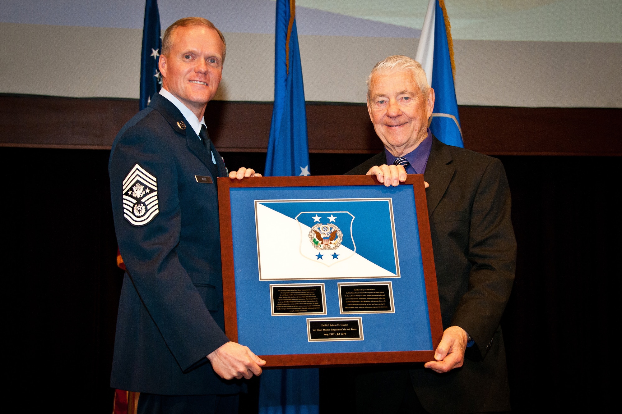 Maxwell Air Force Base, Ala. - Chief Master Sergeant of the Air Force James A. Cody, presents the CMSAF positional colors, to retired Chief Master Sergeant Robert D. Gaylor, fifth CMSAF, at the Air Force Senior Noncommissioned Officer Academy, Thursday, Feb. 27, 2014. Airmen from Maxwell gathered to honor the former Chief Master Sergeants and surviving family members during the ceremony. (USAF photo by Donna L. Burnett/Released)