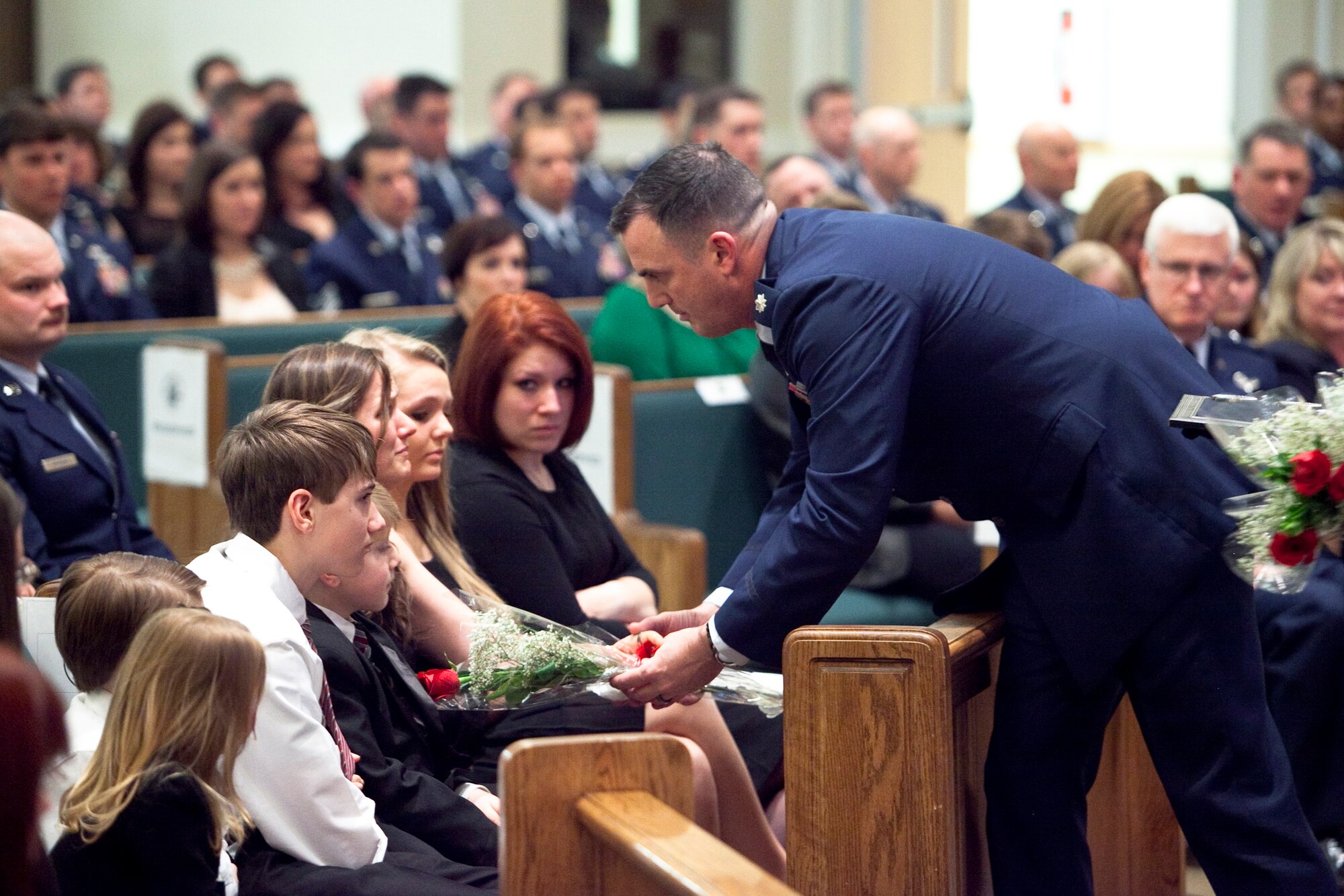 Alyssa Gavulic accepts a rose during the memorial service for her husband, Master Sgt. Josh Gavulic, at the Main Post Chapel at Fort Benning, Ga., on February 28, 2014. (U.S. Army Photo by Patrick Albright/MCoE Photographer)
