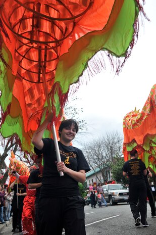 Barbi Beegle, a volunteer among 60 from Beale Air Force Base, carries the dragon at the Bok Kai Parade in Marysville, Calif., March 1, 2014. The dragon named Hong Wan Lung, the lucky dragon, is 175 feet long. It is believed that the longer the dragon the more luck it brings to the community. (U.S. Air Force photo by Airman 1st Class Shana Wojcik/Released)