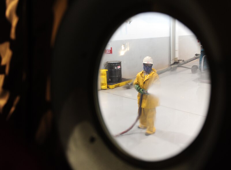 U.S. Air Force Airman 1st Class Robert Kaufman, 317th Aircraft Maintenance Squadron aerospace propulsion apprentice, washes a C-130J Feb. 25, 2014, at Dyess Air Force Base, Texas. C-130Js are washed every 180 days to prevent and control corrosion. (U.S. Air Force photo by Senior Airman Kia Atkins/Released)