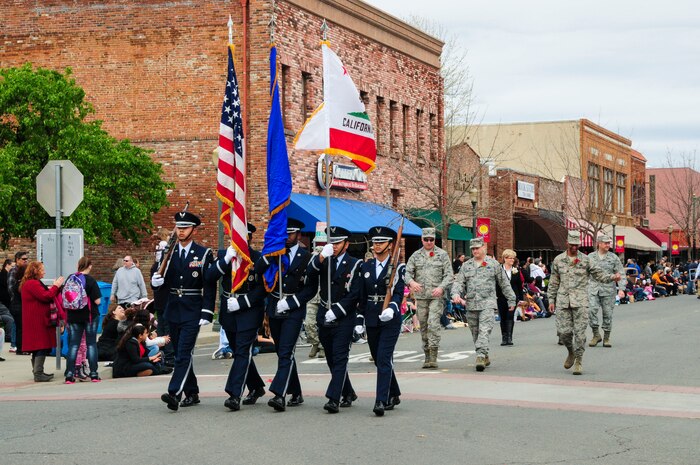 The Beale Air Force Base Honor Guard followed by wing leadership march down E Street in downtown Marysville, Calif., during the annual Bok Kai Festival Parade March 1, 2014. Since starting in 1880, the Bok Kai Parade has become the oldest continually held parade in California. (U.S. Air Force photo by Airman 1st Class Adrian Brown/Released)