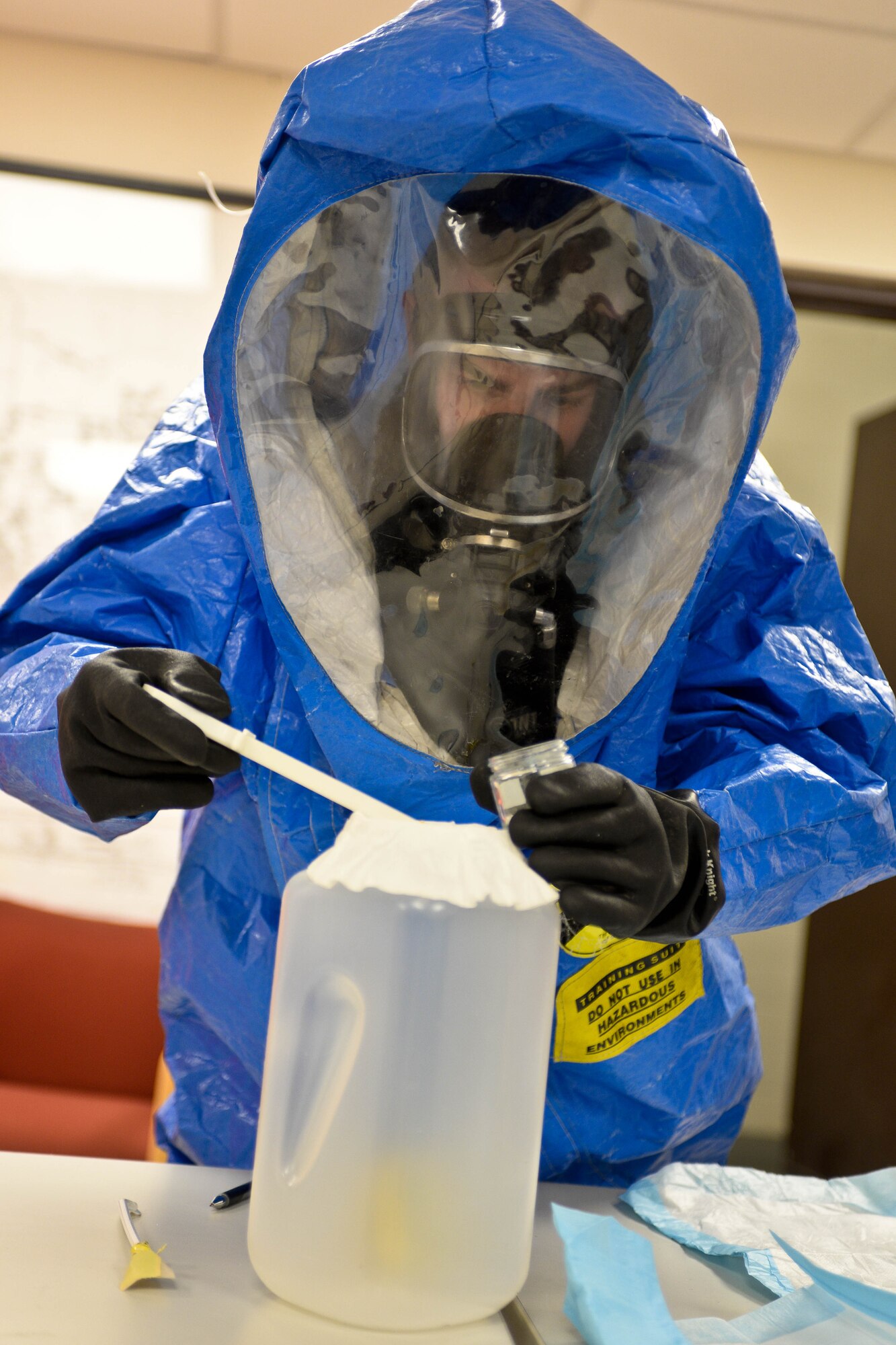U.S. Army Sgt. Alex Page, 82nd Civil Support Team survey team member, collects samples of a simulated unknown substance during a training exercise at Ellsworth Air Force Base, S.D., Jan. 23, 2014. The exercise was designed to test the ability of 82 CST members to respond and collect unknown substances that may pose a threat to lives. (U.S. Air Force photo by Senior Airman Zachary Hada/Released)