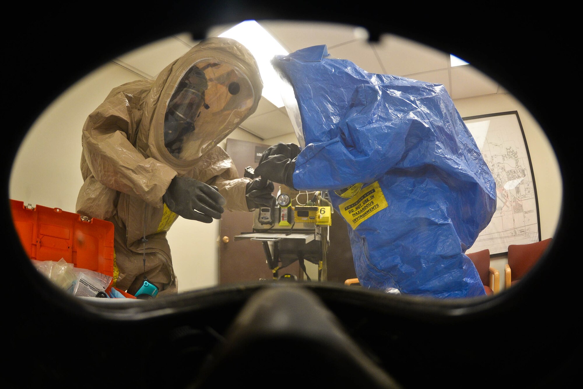 U.S. Army Staff Sgt. Robert Robertson, 82nd Civil Support Team survey team chief, and U.S. Army Sgt. Alex Page, 82nd CST survey team member, collect samples of a simulated unknown substance during a training exercise at Ellsworth Air Force Base, S.D., Jan. 23, 2014. The 82nd CST team consists of 22 individuals trained to assist authorities in response to chemical, biological, radiological, nuclear and explosive threats. (U.S. Air Force photo by Senior Airman Zachary Hada/Released)