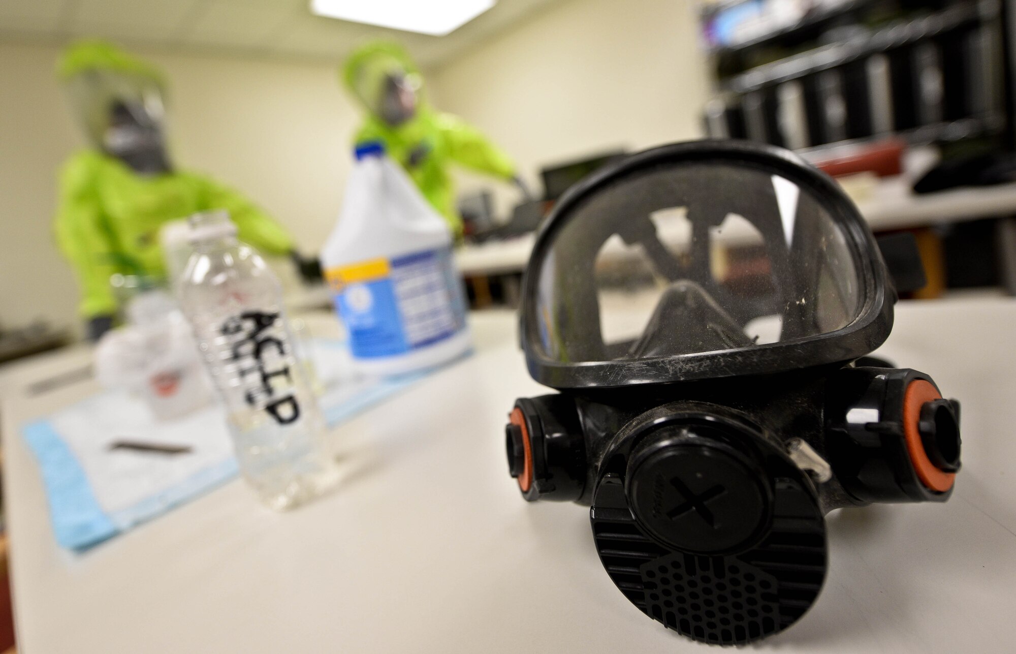 Senior Airman Matthew Hung, and Airman 1st Class Ricky Schutter, 28th Civil Engineer Squadron emergency management technicians, survey simulated unknown substances during a training exercise at Ellsworth Air Force Base, S.D., Jan. 23, 2014. Responders don protective masks under their level A hazardous material suits to guarantee that they remain unharmed from any chemical or biological attacks. (U.S. Air Force photo by Senior Airman Zachary Hada/Released)