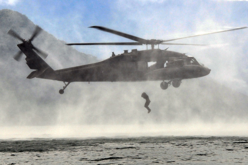 A member of Joint Task Force-Bravo jumps from a UH-60 Blackhawk helicopter during helocast training at Lake Yojoa, Honduras, Feb. 25, 2014. Several members of the Task Force spent the day training on helocasting, caving ladder, and overwater hoist operations. (U.S. Air Force photo by Capt. Zach Anderson)